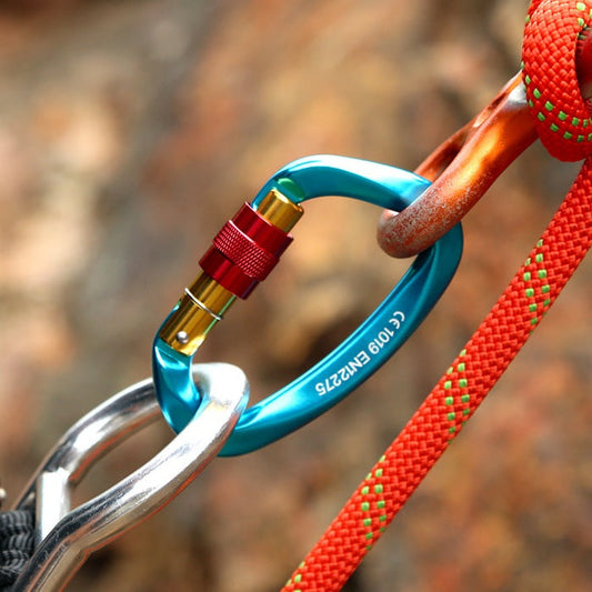Xinda carabiner connected to anchor on rock face